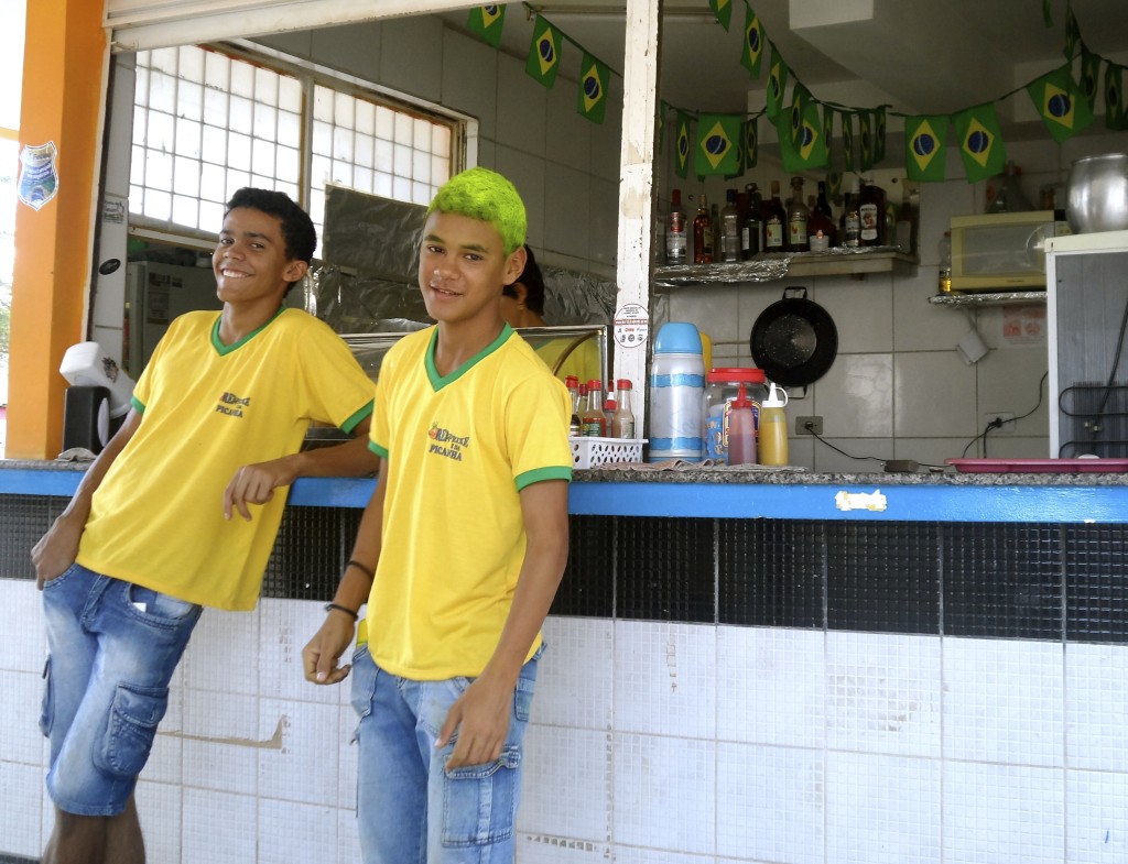 Young waiter with world cup colors in his hair.