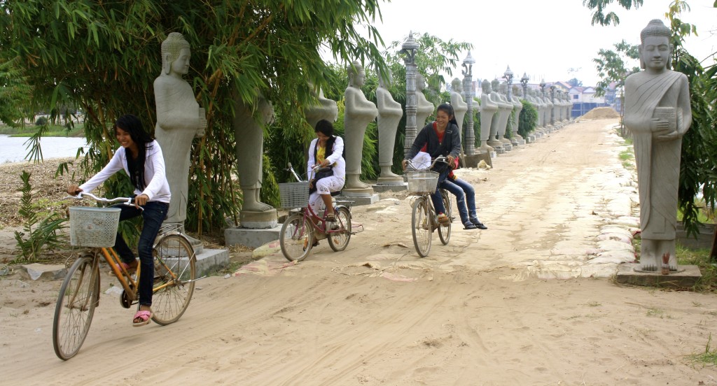 Pretty cambodian girls, cycling home from school.