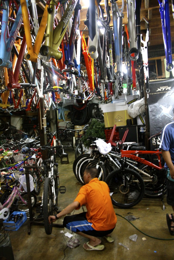 Getting some repair done at a bicycle shop in Manila.