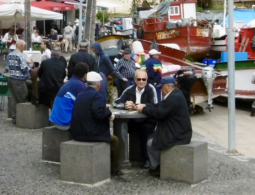 Old men playing cards by the harbour in Camara de Lobos.