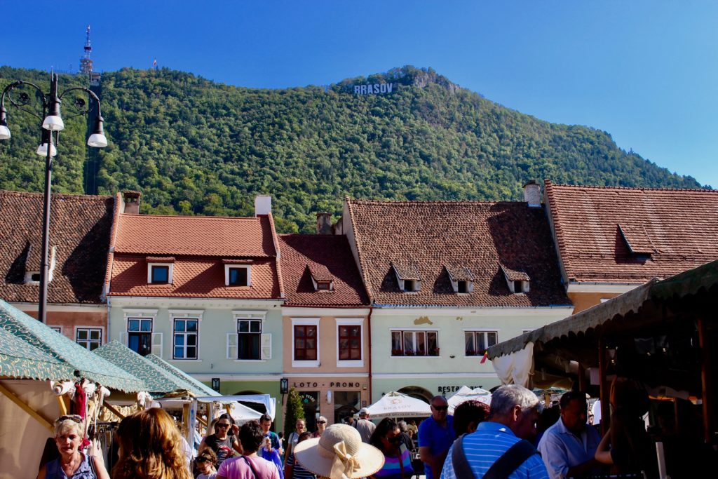 Brasov is a lively town surrounded by mountains.