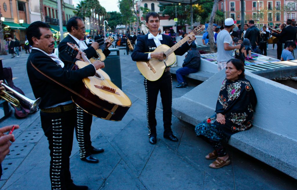 Mariachi band serenading for an elderly lady.